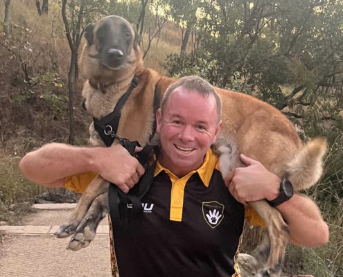 Man carrying dog